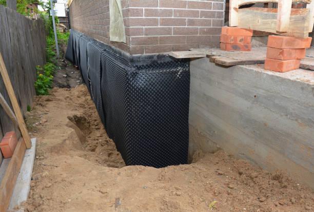 SJ Waterproofing Pros technician performing targeted Interior Drainage System assessment in Foster, KY